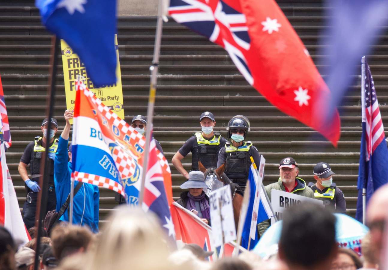 Police keep watch from parliament steps during Eureka Freedom rally in Melb...