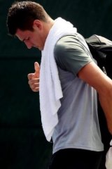 Humiliated: Bernard Tomic leaves the court.
