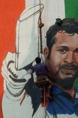 Image of a champion: artist Ranjit Dahiya paints a mural of Sachin Tendulkar on a wall in Mumbai.