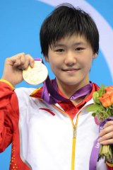 Ye Shiwen holds her gold medal on the podium of the women's 400m individual medley final