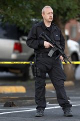 A SWAT team officer stands watch near an apartment where the shooting suspect lived in Aurora, Colorado.
