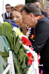 Julia Gillard and her partner Tim Mathieson lay a wreath at a ceremony marking Remembrance day at the National Cemetery of the Pacific in Honolulu, Hawaii.