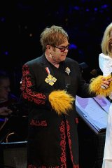 Meryl Streep performs at a benefit concert with Elton John and Sting.