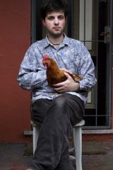 Activist Fregmonto Stokes aka Twiggy Palmcock poses for a portrait with his chicken Umberta Eggo at his Erskineville home.