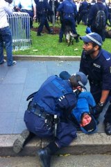 Police arrest protesters in Sydney today.
