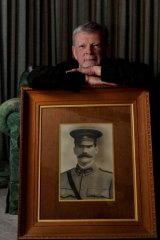 John Sheridan with a portrait of his grandfather Captain Thomas Sheridan who died in the World War I Battle of Fromelles.