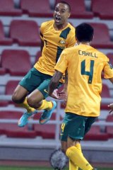 Jumping for joy .... Archie Thompson celebrates his winning goal with Tim Cahill.