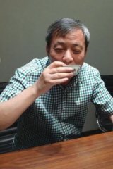 Chinese collector Liu Qiqian drinks tea from the $39 million porcelain cup he bought at Sotheby's Hong Kong.