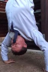 The Facebook image of Andrew Laming skolling a beer while doing a handstand.