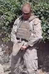 A video still apparently showing a US marine urinating over a body.