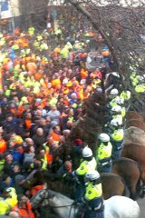 Construction workers and police face off.