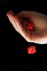 A croupier at Crown Casino has been charged over a rigged dice game