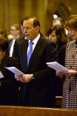 Abbott talks tough: Prime Minister Tony Abbott with wife Margaret at a memorial service for victims of the MH17 crash.
