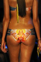 A model parades swimwear featuring the Hindu god Krishna by Lisa Blue during the Australian Fashion Week.