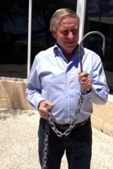 Premier Colin Barnett with one of the hooks used to catch sharks.