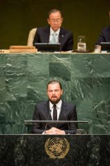 Star power: Leonardo DiCaprio, with Secretary General Ban Ki-moon behind, addresses the UN.
