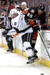 Drew Doughty (8) of the Los Angeles Kings checks Emerson Etem (65) of the Anaheim Ducks at a game in May. 
