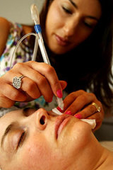 Ilesha Haywood carries out a Jet Peel procedure on a patient at her skin clinic in Thornbury.