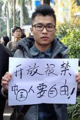 The demonstrator calls for a free press in China.