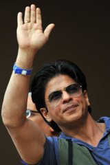 Held by security ... Bollywood star Shah Rukh Khan.