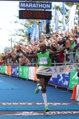 Nicholas Manza crosses the finish line in the Gold Coast marathon .... so close yet so far from bonus cash prize.