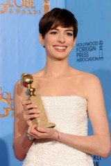 Anne Hathaway with the Golden Globe she won for <i>Les Miserables</i> in 2013.
