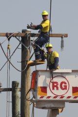 Electricity workers repair a line.
