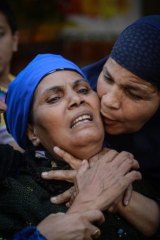 Egyptian women react after the mass death sentence was upheld outside the courtroom in Minya.