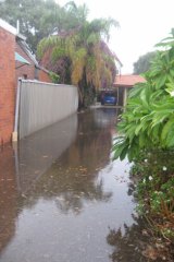 The flooded driveway of a complex in Victoria Park.