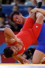 Australia's Farzad Tarash competes against North Korea's Ri Jong Myong.