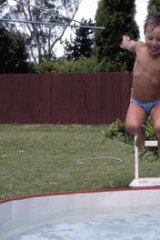 Water world … taking the plunge in his childhood backyard pool.