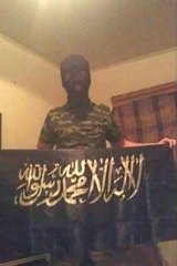 18-year-old shooting victim and terror suspect Numan Haider poses with a jihad flag.