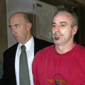 September 2004: During a kidnapping case, Stephen Asling (right) is led into court in Bendigo.
