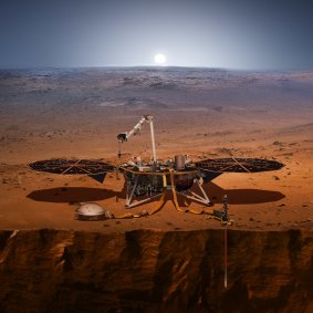 This illustration made available by NASA in 2018 shows the InSight lander drilling into Mars. 
