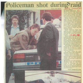 August 1990: Michael Lamb leans against a squad car after Ben Piper was shot.