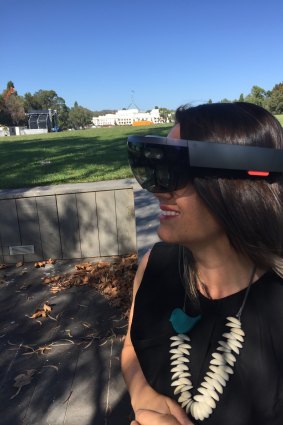 Mikaela Jade using VR goggles. 