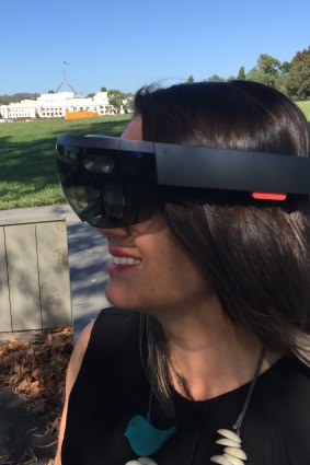 Mikaela Jade using VR goggles. 