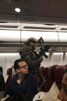 Police storm flight MH128 after a man allegedly tried to enter the cockpit.