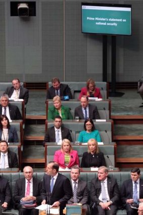 New screens on the floor of the House of Representatives display Prime Minister Tony Abbott's statement on national security. Photo: Andrew Meares