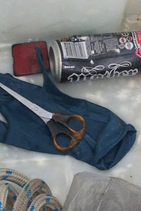 Police divers recover the scissors believed to have been used to cut a teenager's ear during a robbery on the Gold Coast.