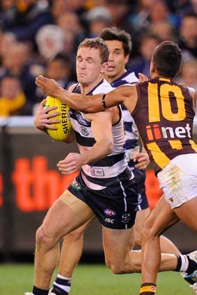 Joel Selwood is tackled high by Hawthorn's Bradley Hill.
