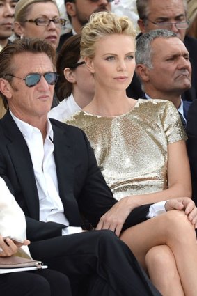 Sean Penn and Charlize Theron attend the Christian Dior show as part of Paris Fashion Week - Haute Couture Fall/Winter 2014-2015 on July 7, 2014 in Paris.