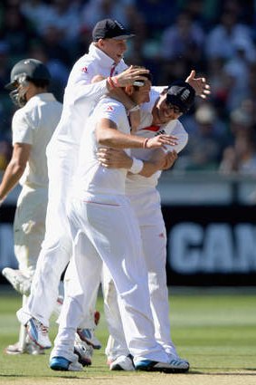 Joe Root and catcher Jimmy Anderson mob Tim Bresnan after Mitch Johnson's dismissal.