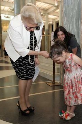 Speaker Bronwyn Bishop compares shoes with Tina Salgado (left) and Sophia Salgado (right) at the Parliament House giving tree. Photo: Alex Ellinghausen