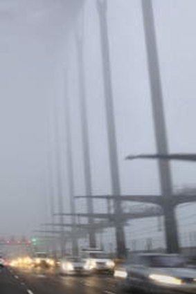 A thick blanket of fog descends on the Sydney Harbour Bridge.