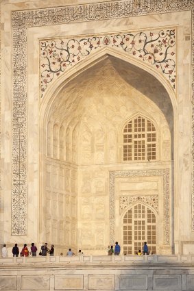 Late afternoon light on the marbled western facade of the Taj Mahal highlights some of the discolouration.