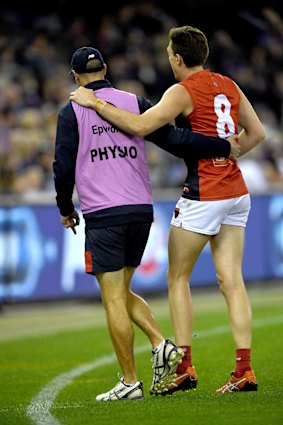 Jake Lever is assisted off the ground.