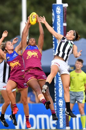 Sabrina Frederick-Traub (centre) of the Lions takes a mark during the Round 6 AFLW match between the Brisbane Lions and the Collingwood Magpies in 2018.