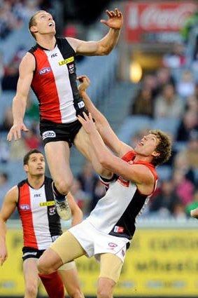 Up, up and away: St Kilda's Ben McEvoy soars over Demon Jake Spencer at the MCG on Saturday. 