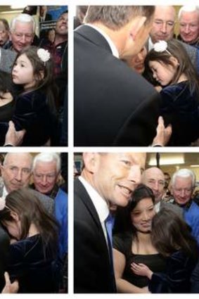 Opposition leader Tony Abbott meets 4 year old Tess Stansfield during the campaign launch for candidates Tanya Denison and Bernadette Black, in Hobart on Thursday.